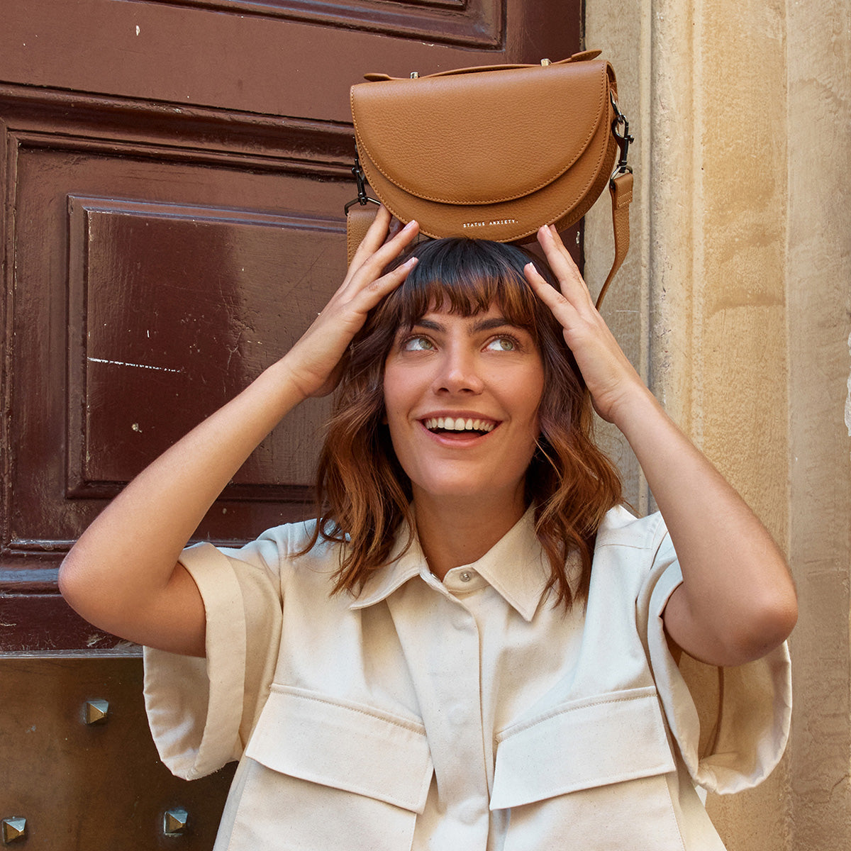 Status anxiety tan bag hotsell